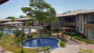 a pool in a courtyard of a resort at Bioflora 69 Itacimirim in Camacari +12 photos