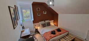 a bedroom with a bed in a room with a window at La Halte D'Aristide - Parking in Cravanche