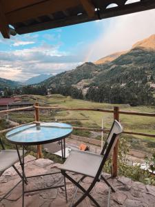 a table and a chair sitting on a patio with a view at Mama Raywa in Chavín de Huantar