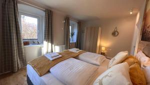 En eller flere senge i et værelse på Landhaus Vorderberg - Appartementen