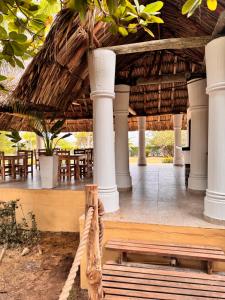 a pavilion with tables and chairs in a resort at Hostal nido tortuga in San Antero