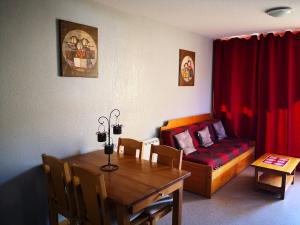 een woonkamer met een bank en een eettafel bij Appartement Super-Dévoluy in Le Dévoluy