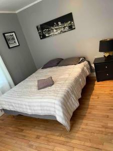 a bed in a bedroom with a wooden floor at Cozy home in Bangor Maine in Bangor