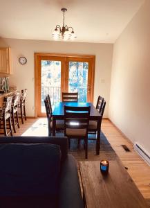 a dining room with a blue table and chairs at Durango Colorado Four Bedroom Two Bathroom Home in Durango