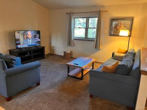 a living room with two couches and a flat screen tv at Durango Colorado Four Bedroom Two Bathroom Home in Durango