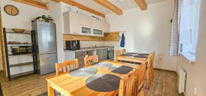 a kitchen with a table and chairs and a refrigerator at Chalupa Petra in Dolní Morava