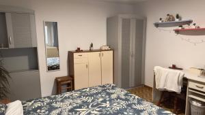 a small room with a bed and a kitchen at Room Pstina in Slap ob Idrijci