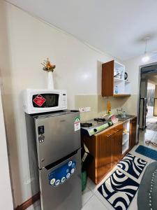 een keuken met een magnetron en een koelkast bij adtek homes Room PENDO in Nairobi