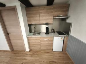 a small kitchen with a sink and a refrigerator at Studio La Maison des Suedois in Saint-Pierre-Bois