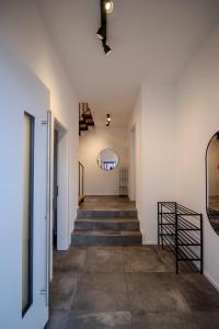 a hallway of a house with stairs and a mirror at betterplaces Homes - Frontenhausen in Frontenhausen