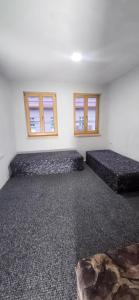 Ένα ή περισσότερα κρεβάτια σε δωμάτιο στο Penzión HUGÁNIK