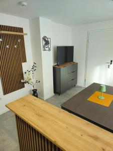 a room with a desk and a tv in it at Froschgass Apartments in Klingenberg am Main