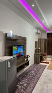 a living room with a flat screen tv on a wall at نيروز بارك in Najran