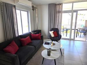 a living room with a couch and a table at Casa Voliere in Stellenbosch