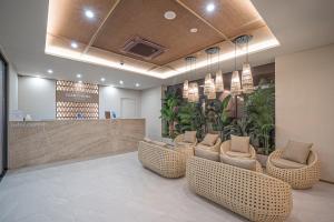 a lobby with a waiting area with chairs and plants at Daegu Dongseongro Giant Hotel in Daegu