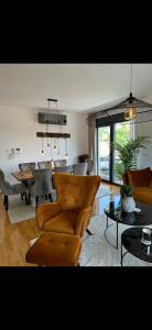 a living room with a couch and a table and chairs at Sky Aslan Mostar in Mostar