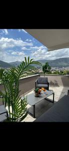 a patio with a couch and a table on a balcony at Sky Aslan Mostar in Mostar