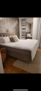 a bedroom with a large bed with white sheets and pillows at Sky Aslan Mostar in Mostar +26 photos