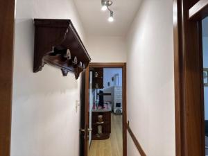 a room with a hallway with a door and a light at Casa Capon in Santo Stefano di Cadore