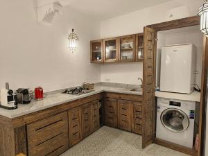 a kitchen with a refrigerator and a washing machine at La Douiria Essaouira Medina in Essaouira +39 photos