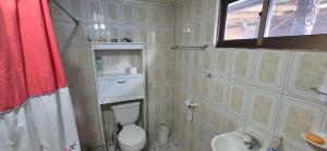 a bathroom with a toilet and a sink at Casa patagonia in Cochrane