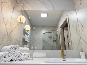 a bathroom with a sink and a mirror at Apartament Comfort Wrocław in Wrocław +20 photos