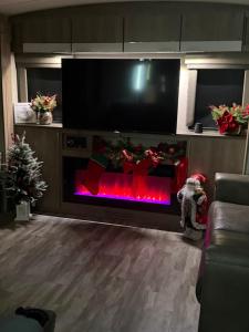 a living room with a fireplace with christmas decorations at Paradise in Tampa