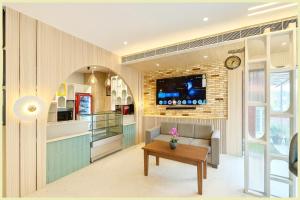 a living room with a couch and a table at Hotel THE RB Near Jagannath Temple And Sea Beach - Parking- Spa With Restaurant - SWIMMING POOL Facilities - Fully Air Conditioning Deluxe Rooms - Prime Location in Puri