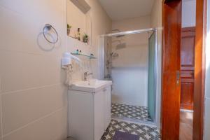 a white bathroom with a shower and a sink at Sophia Hotel Oldcity in Istanbul