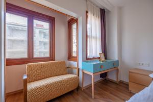 a bedroom with a chair and a table and window at Sophia Hotel Oldcity in Istanbul +29 photos