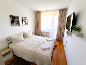 a bedroom with a bed and a window at VIP Apartment Belvedere Club in Bansko +71 photos