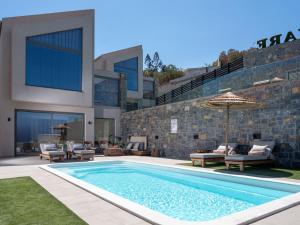 a swimming pool in front of a building at Ligaria Mare in Agia Pelagia