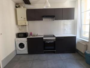 a kitchen with a sink and a washing machine at Appartement Cosy du château in Sedan +7 photos