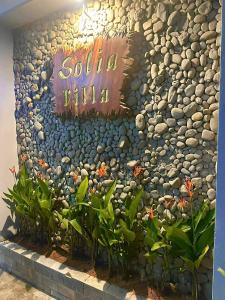 a rock wall with a sign that reads santa villa at Solia Villa in Da Nang