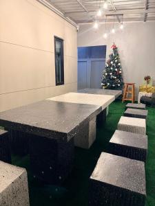 a room with a table and a christmas tree at My Own House SURAT THANI in Ban Huai Chiat