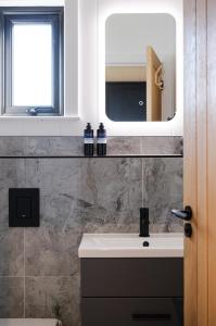 a bathroom with a sink and a mirror at Old Fargie Lodges in Perth
