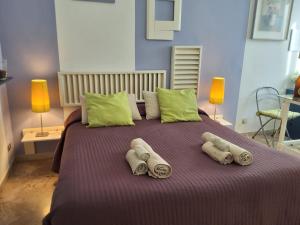 a large bed with two pillows on top of it at Mascagni Rooms in Florence