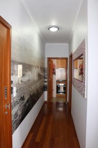 a hallway with a painting on the wall at Uptown Madalenas in Funchal