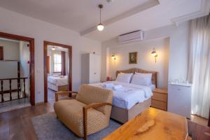 a bedroom with a bed and a chair and a table at Sophia Hotel Oldcity in Istanbul