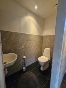 a bathroom with a white toilet and a sink at Rymlig lägenhet I hjärtat av Lindesberg 95kvm in Lindesberg +20 photos