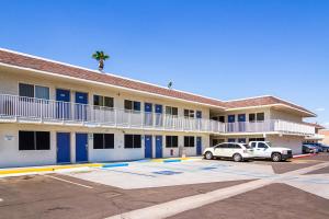 a hotel with a car parked in a parking lot at Motel 6 Mesa North in Mesa