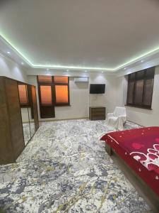 a large room with a bed and a large rug at Best Apartments in Khujand +6 photos