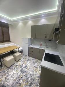 a kitchen with a sink and a counter top at Best Apartments in Khujand