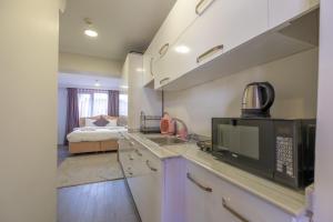 a kitchen with a microwave and a bed in a room at Sophia Hotel Oldcity in Istanbul