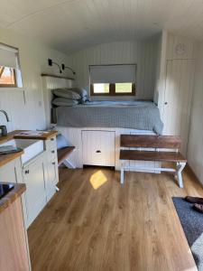 a bedroom with a bed and a bench in it at The Shepherds Rest in East Dean