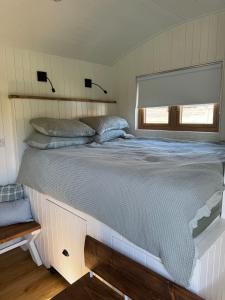 a large bed in a bedroom with a window at The Shepherds Rest in East Dean