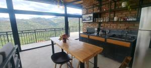 una cucina con tavolo e un balcone con vista di Tampu Wasi a Vilcabamba