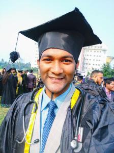 a man in a graduation hat and tie is smiling at Dr A Amin Homeopathy Clinic in Kolkata