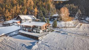 an aerial view of a house in the snow at Der Hof - Perntal Retreat in Gais