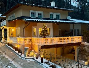 a house with a christmas tree on the balcony at App. Marlos in Leisach